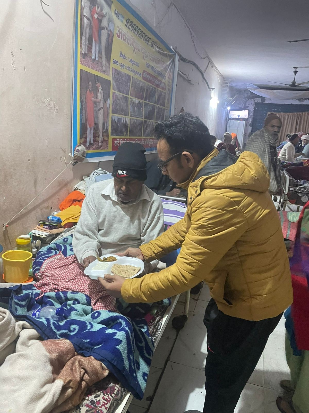 A volunteer serving a meal to an elderly person in a care home